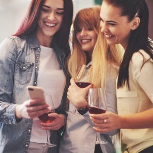 Picture presenting happy group of friends with red wine